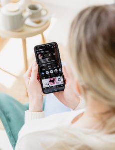 Woman looking at Instagram Reel on her phone.